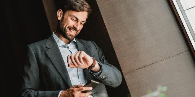 elegant-young-man-looks-at-wristwatch