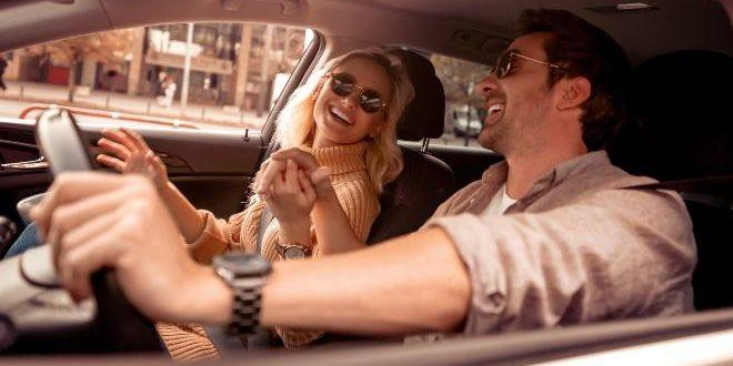 Happy young couple in the car,enjoying together.