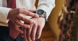 businessman checking time on his wrist watch, man putting clock on hand,groom getting ready in the morning before wedding ceremony. Men Fashion