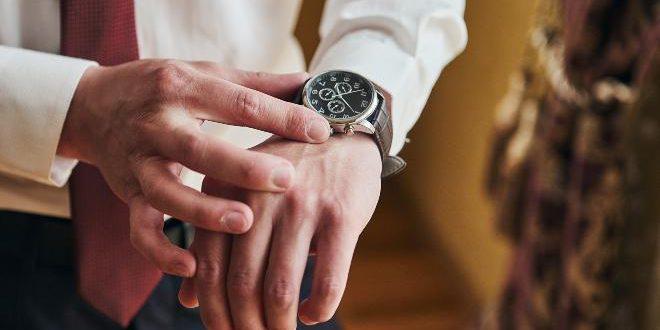 businessman checking time on his wrist watch, man putting clock on hand,groom getting ready in the morning before wedding ceremony. Men Fashion